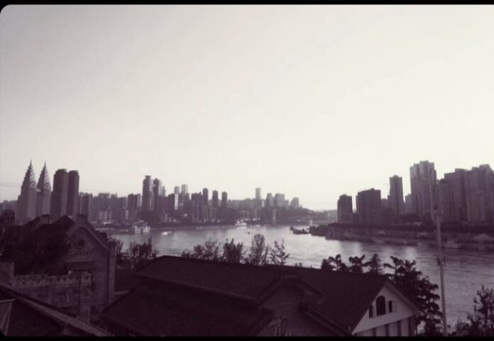 Black and white photograph of an ultramodern bridge and skyscrapers in the background, in the Chinese megalopolis Chongqing.