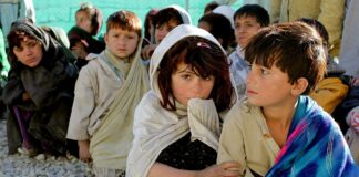 Economy after covid, picture of children sitting on the ground in a poor area of the world