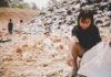 World hunger: permanent emergencies, asian girl scattering in a dumpsite