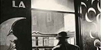Paris literature, vintage picture, black and white, man from behind in front of a shop window