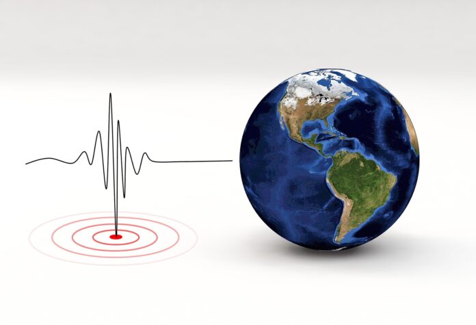 in this coloured photo you can see, on the right, a globe, and on the left, a stock chart like an electrocardiogram