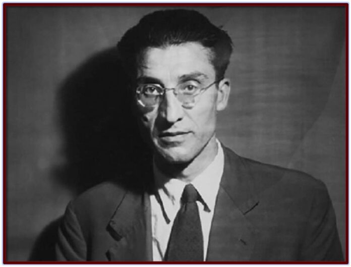 Black and white photo of Cesare Pavese, half body, suit and tie on dark background