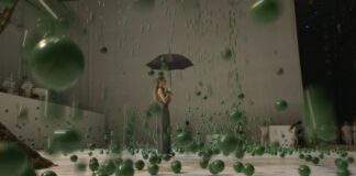 Alexander Ekman choreographer from Sweden, scene of his ballet, ballerina with umbrella, raining green balls