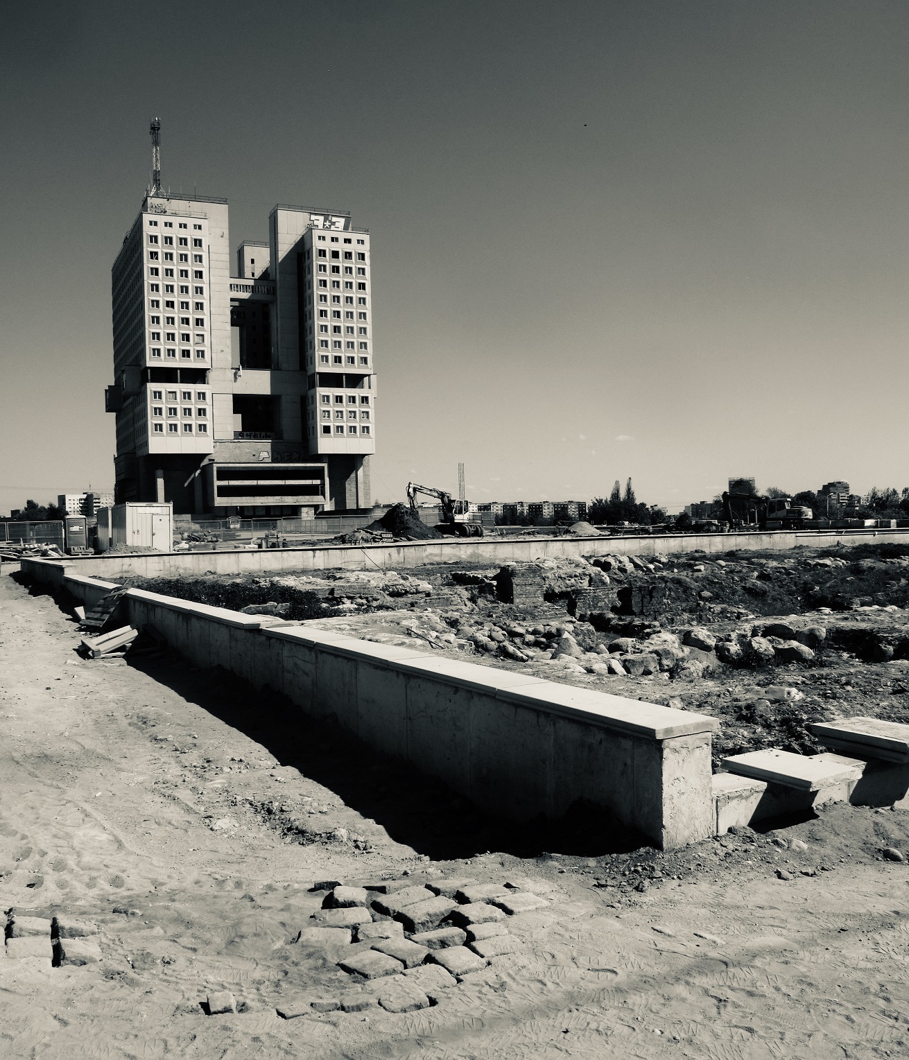 in the black and white photo you can see a building, the Palace of the Soviets, with an antenna on the roof