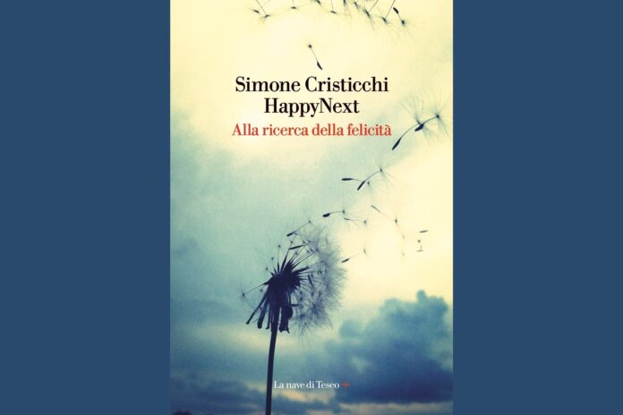 la foto a colori mostra la copertina di un libro, Happy Next di Simone Cristicchi, che reca l'immagine di un fiore bianco con parti portate via dal vento