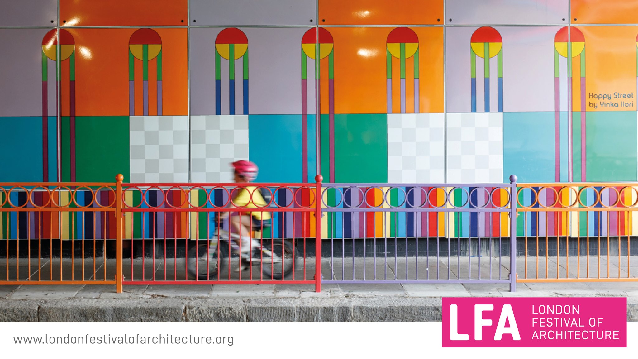 London Festival of Architecture, the poster: a colorful wall, a boardwalk with a baby boy on a bicycle, a colorful protective railing